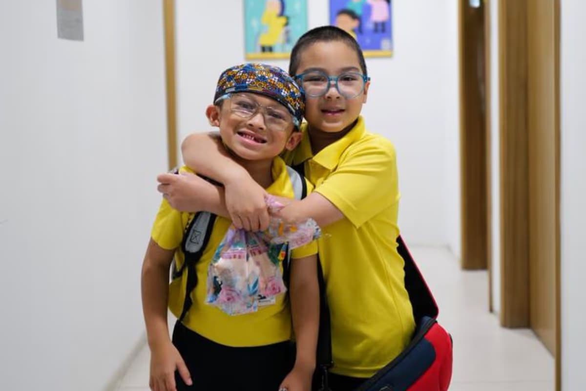 EIPP - Key Learning Area - Social Skills and Interaction - Two students hugging each other